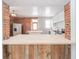 Bright kitchen with white cabinets, stainless steel appliances, and exposed brick wall at 503 S Harrison St, Alexandria, IN 46001