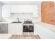 Modern kitchen with white cabinets, stainless steel appliances, and light wood countertops at 503 S Harrison St, Alexandria, IN 46001