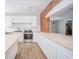 Modern kitchen featuring white cabinets, stainless steel appliances, and wood-look flooring at 503 S Harrison St, Alexandria, IN 46001