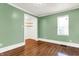 Charming bedroom with hardwood floors, closet, and window at 5233 Chelsea Rd, Indianapolis, IN 46241