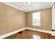 Bright bedroom with hardwood floors and a window at 5233 Chelsea Rd, Indianapolis, IN 46241