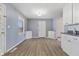 Bright dining area with light grey walls and wood-look flooring at 5249 Hickory Rd, Indianapolis, IN 46239