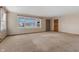 Spacious living room with neutral carpeting and large windows at 5249 Hickory Rd, Indianapolis, IN 46239