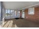 Sunroom features brick wall, carpet and view of the yard at 5249 Hickory Rd, Indianapolis, IN 46239