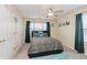 Bright bedroom with a double bed and teal colored accents at 6023 Twyckenham Dr, Indianapolis, IN 46236