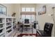 Home office with built-in shelving, desk, and comfortable seating at 6023 Twyckenham Dr, Indianapolis, IN 46236