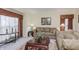 Living room with neutral carpeting, taupe sofas, and coffee table at 6023 Twyckenham Dr, Indianapolis, IN 46236