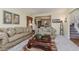 Living room with neutral carpeting, taupe sofas, and coffee table at 6023 Twyckenham Dr, Indianapolis, IN 46236