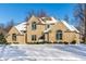 Brick home with a snow covered yard at 7488 River Highlands Dr, Fishers, IN 46038