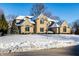 Brick home with snow-covered yard at 7488 River Highlands Dr, Fishers, IN 46038