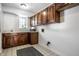 Laundry room with wood cabinets and tile floor at 7488 River Highlands Dr, Fishers, IN 46038