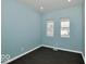 Well-lit bedroom, featuring dark hardwood floors and light blue walls at 835 N Oxford St, Indianapolis, IN 46201