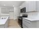 Modern kitchen with gray cabinets, quartz countertops, and stainless steel appliances at 9703 Behner Dr, Fishers, IN 46250