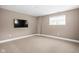 Finished basement with neutral carpeting and wall-mounted TV at 1003 Alabama St, Indianapolis, IN 46202