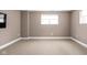 Finished basement room with neutral carpeting and window at 1003 Alabama St, Indianapolis, IN 46202