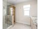 Bathroom with glass shower, granite countertop, and wooden cabinet at 1003 Alabama St, Indianapolis, IN 46202