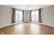 Spacious bedroom with herringbone floors and two large windows at 1003 Alabama St, Indianapolis, IN 46202