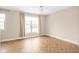 Bright bedroom with herringbone floors and large window at 1003 Alabama St, Indianapolis, IN 46202