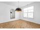 Dining room with herringbone floors and a large window at 1003 Alabama St, Indianapolis, IN 46202