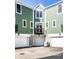 View of garages and rear balconies highlighting a modern, low-maintenance design with exterior lighting and ample parking at 1003 Alabama St, Indianapolis, IN 46202