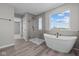 Modern bathroom featuring a glass-enclosed shower, freestanding tub, and stylish fixtures at 1069 Ridgevine Rd, Greenwood, IN 46143