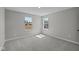Neutral bedroom features two windows for natural light and plush carpet at 1069 Ridgevine Rd, Greenwood, IN 46143