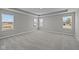 Bedroom with multiple windows, tray ceilings, and neutral color palette at 1069 Ridgevine Rd, Greenwood, IN 46143