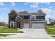 Attractive brick home featuring a spacious driveway leading to a three-car garage at 1069 Ridgevine Rd, Greenwood, IN 46143