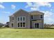 Rear exterior view showcasing large windows and sliding doors offering a view of the backyard at 1069 Ridgevine Rd, Greenwood, IN 46143