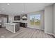 Inviting kitchen with an island, modern lighting, and view of the backyard at 1069 Ridgevine Rd, Greenwood, IN 46143