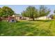 Large grassy backyard with playset and trampoline at 1801 Witt Rd, Lebanon, IN 46052