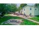 View of the house's back and the deck with a water feature and fire pit at 1801 Witt Rd, Lebanon, IN 46052