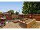 Spacious backyard with raised garden beds and a wooden fence at 1801 Witt Rd, Lebanon, IN 46052