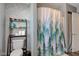 Clean bathroom with a toilet and shower with a forest-themed curtain at 1801 Witt Rd, Lebanon, IN 46052