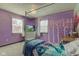 Purple bedroom with a mural, bed, and a desk at 1801 Witt Rd, Lebanon, IN 46052