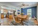 Bright dining area with wood table and chairs, wood floors, and kitchen views at 1801 Witt Rd, Lebanon, IN 46052