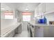 Bright laundry room, featuring washer, dryer, and ample counter space at 1801 Witt Rd, Lebanon, IN 46052