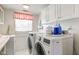 Clean laundry room with washer, dryer, and built-in cabinets at 1801 Witt Rd, Lebanon, IN 46052