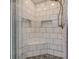 Spacious shower with built-in seat and subway tile at 1801 Witt Rd, Lebanon, IN 46052