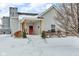 Charming bungalow with a covered porch and snow-covered yard at 227 W South St, Greenfield, IN 46140