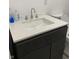 Modern bathroom vanity with a white quartz countertop and dark gray cabinets at 2722 Collier St, Indianapolis, IN 46241