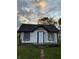 Newly renovated home exterior boasts white siding and a black roof at 2722 Collier St, Indianapolis, IN 46241