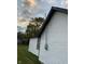 White vinyl siding with black window frames and electric meter at 2722 Collier St, Indianapolis, IN 46241
