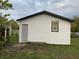 White vinyl siding with black window frames and gray door on the side of the house at 2722 Collier St, Indianapolis, IN 46241