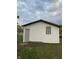 White vinyl siding with black window frames and gray door on the side of the house at 2722 Collier St, Indianapolis, IN 46241