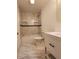 Modern bathroom with marble tile, a bathtub, and a white vanity at 2817 S Rybolt Ave, Indianapolis, IN 46241
