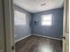 Simple bedroom with gray walls and wood-look flooring at 2817 S Rybolt Ave, Indianapolis, IN 46241