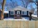 Newly renovated home with blue siding, white trim, and a snow-covered yard at 2817 S Rybolt Ave, Indianapolis, IN 46241