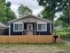 Charming single-story home featuring a cozy front porch and a well-maintained lawn with wood fence at 2817 S Rybolt Ave, Indianapolis, IN 46241