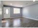 Spacious living room with gray walls and wood-look flooring at 2817 S Rybolt Ave, Indianapolis, IN 46241